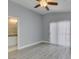 Bedroom with ceiling fan, sliding glass doors to balcony, and adjacent bathroom at 1334 Shimmering Glen Ave, Henderson, NV 89014