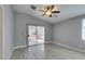 Bedroom with vaulted ceiling, ceiling fan, and sliding glass doors to patio at 1334 Shimmering Glen Ave, Henderson, NV 89014