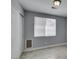 Neutral bedroom featuring a window, closet, and light gray walls at 1334 Shimmering Glen Ave, Henderson, NV 89014