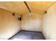 Inside of shed with carpeted flooring, mounted lights, electrical outlets, and paneled walls at 1334 Shimmering Glen Ave, Henderson, NV 89014