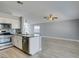Open kitchen and living area featuring stainless steel appliances and a modern island at 1334 Shimmering Glen Ave, Henderson, NV 89014