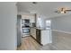 Open kitchen featuring stainless steel appliances and a modern island with sink at 1334 Shimmering Glen Ave, Henderson, NV 89014