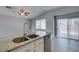 Kitchen island with granite counters and double stainless sink, adjoining the living area at 1334 Shimmering Glen Ave, Henderson, NV 89014