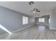 Spacious living room with modern gray floors, ceiling fan, and abundant natural light at 1334 Shimmering Glen Ave, Henderson, NV 89014