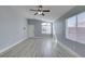 Bright living room featuring wood-look flooring, a large arched window, and a ceiling fan at 1334 Shimmering Glen Ave, Henderson, NV 89014