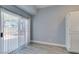 Bright room with vertical blinds and wood-look floors, leading to an outdoor space at 1334 Shimmering Glen Ave, Henderson, NV 89014