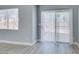 Bright room with sliding glass doors and window, complemented by stylish wood-look floors at 1334 Shimmering Glen Ave, Henderson, NV 89014