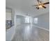 Bright living room leading into the kitchen with light-colored walls, and a modern ceiling fan at 1334 Shimmering Glen Ave, Henderson, NV 89014