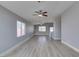 Bright living room featuring wood-look flooring, a large window, and a ceiling fan at 1334 Shimmering Glen Ave, Henderson, NV 89014