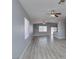 Bright living room featuring wood-look flooring, a large window, and a ceiling fan at 1334 Shimmering Glen Ave, Henderson, NV 89014