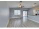 Inviting living room featuring wood floors, view to the backyard, and easy access to the kitchen at 1334 Shimmering Glen Ave, Henderson, NV 89014
