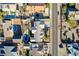 An aerial view of a home with a pool, a green yard, and a detached storage shed at 1630 Sundown Dr, Henderson, NV 89002