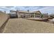 Extensive gravel backyard with black metal fencing and landscaped borders at 1630 Sundown Dr, Henderson, NV 89002