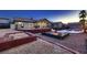 Expansive backyard with a fire pit, patio space, and well-manicured landscaping for an outdoor oasis at 1630 Sundown Dr, Henderson, NV 89002