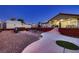 Outdoor living space boasts a fire pit, patio area, and lush landscaping for outdoor relaxation and entertaining at 1630 Sundown Dr, Henderson, NV 89002