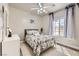 Cozy bedroom with neutral tones, a ceiling fan, and a window with natural light at 1630 Sundown Dr, Henderson, NV 89002