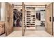 Open walk-in closet showing custom shelving, hanging racks and wood flooring at 1630 Sundown Dr, Henderson, NV 89002