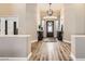 Inviting entryway with wood floors, decorative light fixture and stylish decor creates a warm welcome at 1630 Sundown Dr, Henderson, NV 89002