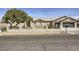 Charming single-story home with a tile roof, an iron fence, a gravel yard, and an attached two-car garage at 1630 Sundown Dr, Henderson, NV 89002