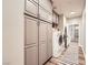 Well-organized laundry room boasts ample gray cabinetry and front load washer and dryer set at 1630 Sundown Dr, Henderson, NV 89002