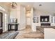Bright living room featuring vaulted ceilings, modern lighting fixtures and stone fireplace at 1630 Sundown Dr, Henderson, NV 89002