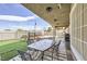 Outdoor patio area with table and chairs, artificial grass and fenced yard at 1630 Sundown Dr, Henderson, NV 89002