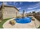 Beautiful inground pool featuring rocks, waterfalls, and a spa creating an inviting backyard retreat at 1630 Sundown Dr, Henderson, NV 89002