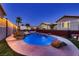 Inviting backyard featuring an inground pool with rock accents and water features for relaxing outdoor enjoyment at 1630 Sundown Dr, Henderson, NV 89002