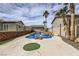 Inviting backyard pool and spa surrounded by a concrete patio and lush landscaping at 1630 Sundown Dr, Henderson, NV 89002