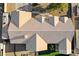Aerial view of the roof, desert landscaping, and patio area with lush green grass at 1630 Sundown Dr, Henderson, NV 89002