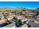 Street view of a single-Gathering home with desert landscaping, view of backyard pool and spa at 1630 Sundown Dr, Henderson, NV 89002