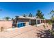 Exterior view of house and backyard featuring covered patio and gravel landscaping at 1900 E Oakey Blvd, Las Vegas, NV 89104