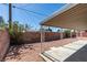 Backyard features a covered patio, gravel groundcover, and a brick fence at 1900 E Oakey Blvd, Las Vegas, NV 89104