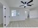 Bedroom features light wood-look flooring, a ceiling fan and access to another room at 1900 E Oakey Blvd, Las Vegas, NV 89104