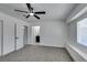 This bedroom offers plush carpeting, a ceiling fan, and a sunlit window for a bright and inviting space at 1900 E Oakey Blvd, Las Vegas, NV 89104