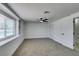 Bright carpeted bedroom featuring ceiling fan and built in shelves at 1900 E Oakey Blvd, Las Vegas, NV 89104