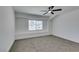 This bedroom offers plush carpeting, a ceiling fan, and a sunlit window for a bright and inviting space at 1900 E Oakey Blvd, Las Vegas, NV 89104