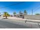 Single story house on residential street with desert landscaping, concrete driveway and mature trees at 1900 E Oakey Blvd, Las Vegas, NV 89104