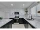 Bright kitchen features stainless steel appliances, sleek white countertops and floating shelves at 1900 E Oakey Blvd, Las Vegas, NV 89104