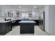White and black kitchen featuring modern appliances, kitchen island and light wood floors at 1900 E Oakey Blvd, Las Vegas, NV 89104