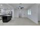 Open-concept kitchen with a black island, stainless appliances, and light wood-look floors at 1900 E Oakey Blvd, Las Vegas, NV 89104