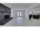 Bright living room with fireplace, open to kitchen, modern flooring and neutral paint at 1900 E Oakey Blvd, Las Vegas, NV 89104
