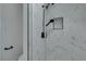 The shower features white marble tiles and black fixtures at 1900 E Oakey Blvd, Las Vegas, NV 89104