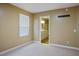 Bright bedroom with a large window and neutral carpeting, leading to a bathroom at 2032 Kingswinford Dr, North Las Vegas, NV 89032