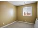 Bedroom featuring a window with neighborhood views and neutral carpeting at 2032 Kingswinford Dr, North Las Vegas, NV 89032