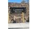 Cambridge Heights community entrance sign set in a stone wall with stacked stone and desert landscaping at 2032 Kingswinford Dr, North Las Vegas, NV 89032