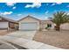 Charming single-story home featuring a two-car garage and desert landscaping at 2032 Kingswinford Dr, North Las Vegas, NV 89032