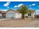 Charming single-story home with a desert rock yard, two car garage, and barrel tile roof at 2032 Kingswinford Dr, North Las Vegas, NV 89032