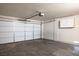 Spacious two-car garage with concrete flooring, white walls, and an automatic door opener at 2032 Kingswinford Dr, North Las Vegas, NV 89032