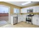 Bright kitchen with stainless steel appliances, white cabinets, and sleek countertops at 2032 Kingswinford Dr, North Las Vegas, NV 89032